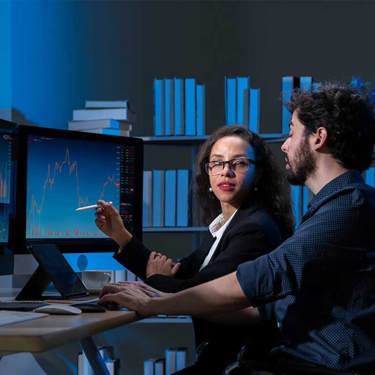 dos oficinistas analizan las gráficas de una computadora para mejora el rendimiento de su ROI